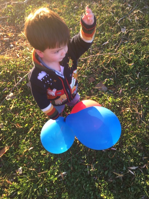 Joey aged two with his balloons having fun